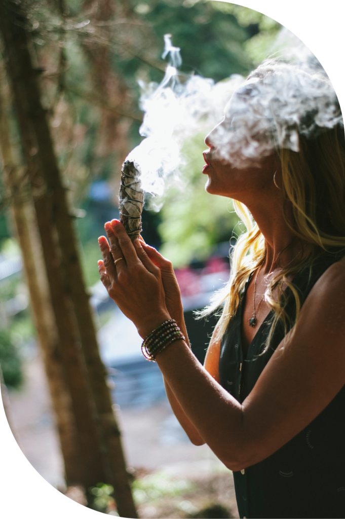 Tove Redeby performing a smudging ceremony in nature